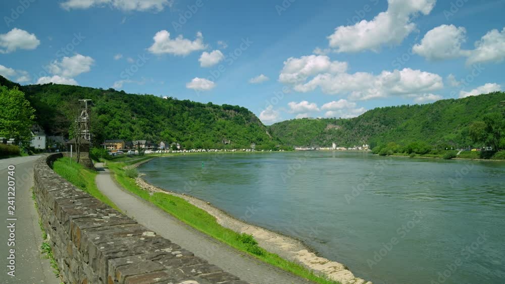 Cargo ship. Loreley Rock at the Rhine River with the City St. Goar in the background, region Rhineland-Palatinate, Germany St. Goar, Central Europe, july 2017 Cargo ship. Loreley Rock at the Rhine River with the City St. Goar in the background, region Rhineland-Palatinate, Germany St. Goar, Central Europe, july 2017