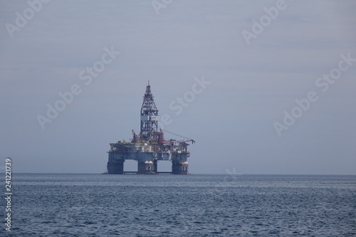 An oil drilling platform in the mist of the west African coast