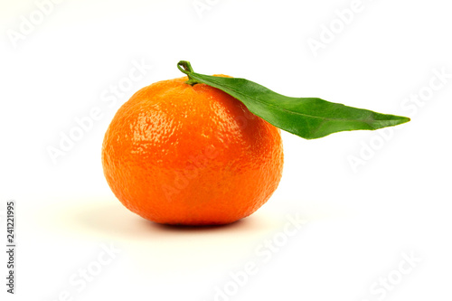 Ripe tangerine on a white background with a green leaf