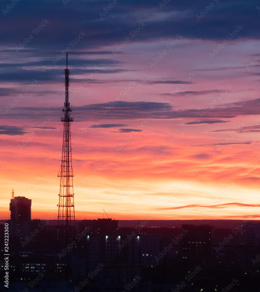 Sunset in the city, on the background of the radio tower