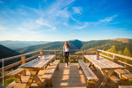 Photography Young woman with long hair have rest in open air cafe on top of mountains and en