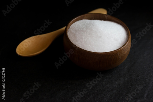 Salt in Cup made of wood with spoon  
