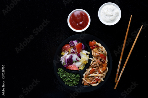 asian food, ready meal to eat in lunch box with sticks and sauce