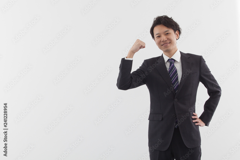 A young Asian business man standing with energy A young Asian business man standing with energy