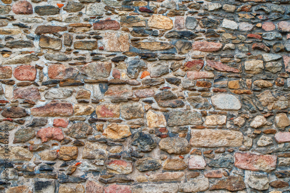 Naklejka premium stone old stone church wall as backgroundwall,
