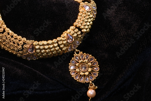 Golden jewelry neck set closeup macro image on black background 