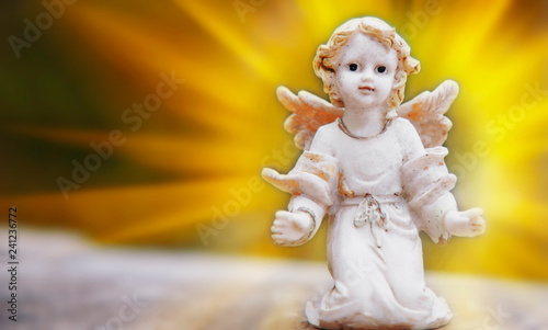 Ancient stone statue of little angel as symbol of guard for children. Love, faith, hope, religion, Christianity, good concept.