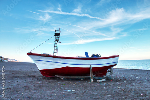 Fishing boat stranded on the beach of Oued Lao, a small coastal town in the province of Chefchaouen, in northern Morocco