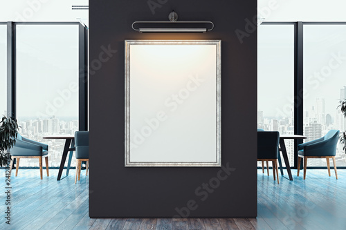 Fototapeta Naklejka Na Ścianę i Meble -  White blank canvas poster on dark wall in modern bright office, 3d rendering.