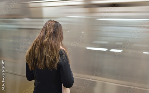 Young Woman Waiting for NYC Subway Train on MTA Platform