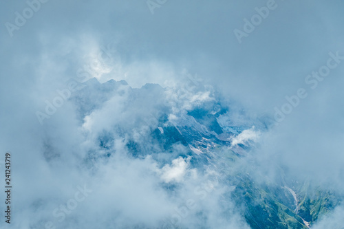 Mountain peaks hidden by clouds