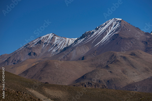 Snow capped peaks and rugged landscape of the altiplano, around 4000 metres above sea level, in Lauca National Park, Chile. 