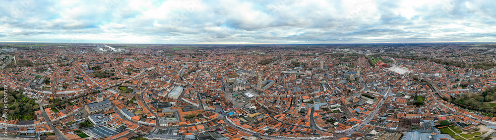 Panoramic aerial view of Bruges from above of historic city is distinguished by its canals, cobbled streets and medieval buildings with historical landmarks and city town center in Belgium