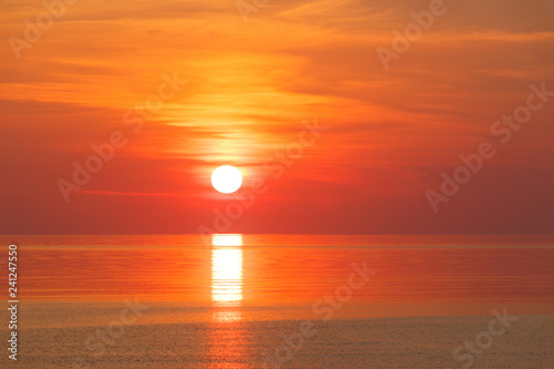 Peaceful orange red sea sunrise