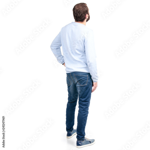 Man in jeans back behind on a white background. Isolation.