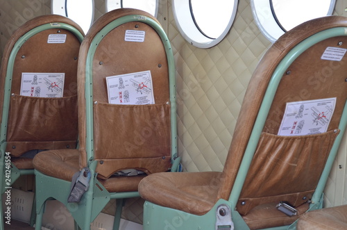 inside the plane, one sees old chairs and windows, where the passengers were accommodated. photo