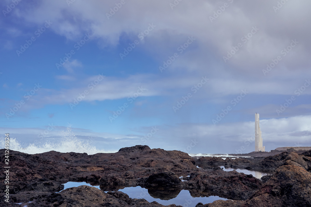 Faro de Punta del Hidalgo, Tenerife Black Stone Coast overlooking the rough Atlantic Sea on a rainy day