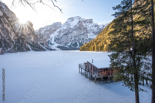 Boathouse on the frozen braies lake without people. South-Tirol,.Italy