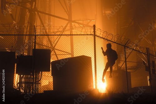 Male climbing fence silhouette  photo