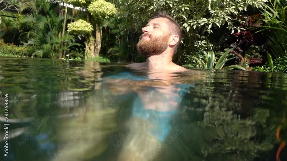 Young man relaxing in the swimming pool Young man relaxing in the swimming pool
