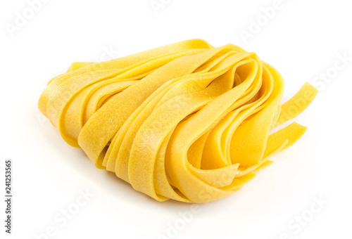 Raw yellow italian pasta pappardelle, fettuccine or tagliatelle photo