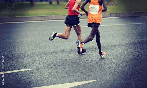 Marathon runner legs running on city road