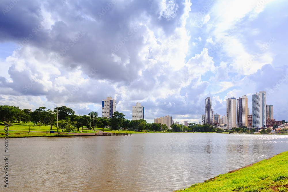 Partial view of the lake in the Parque das Nações Indígenas and buildings in the background, in the city of Campo Grande, capital of Mato Grosso do Sul, Brazil. City in the middle of nature