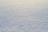 High angle view of snow texture, background with copy space. Snow texture or winter white background with grain rough pattern