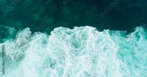 Top down aerial view of abstract ocean waves crashing creating unique patterns