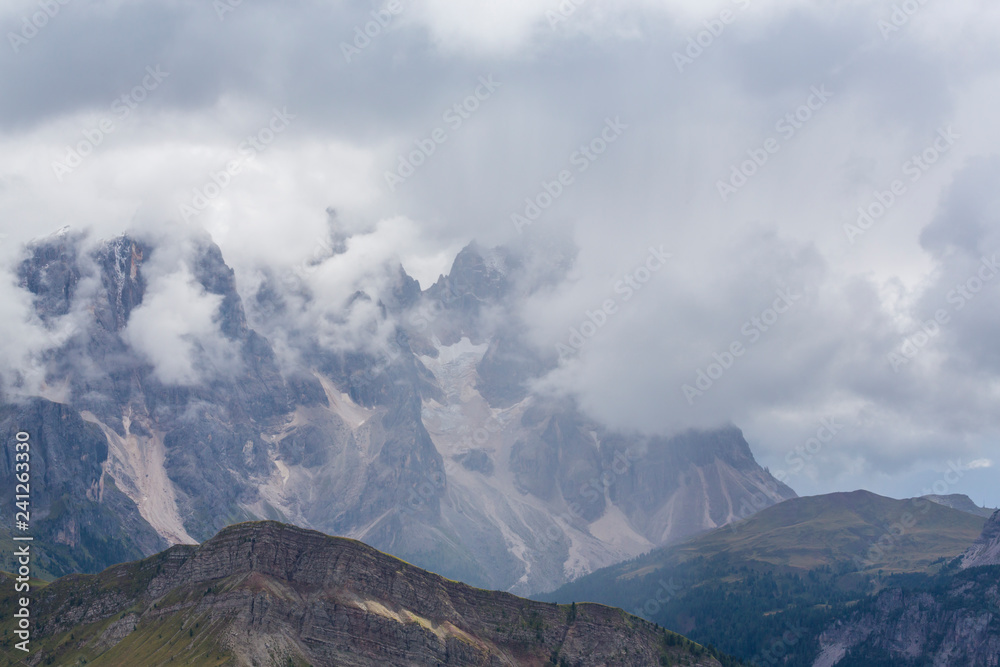 Beautiful scenery in the Dolomite Alps, with rain clouds, mist, and limestone peaks