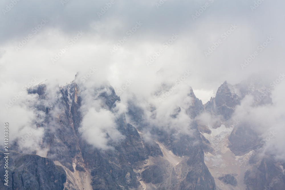 Beautiful scenery in the Dolomite Alps, with rain clouds, mist, and limestone peaks