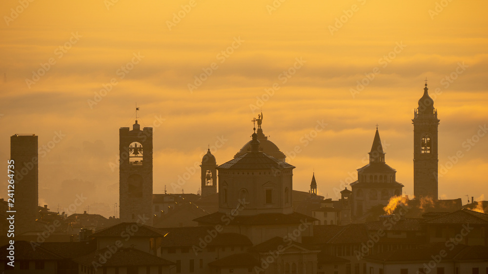 Bergamo, one of the most beautiful city in Italy. Amazing landscape of the old town and the fog covers the plain at sunrise