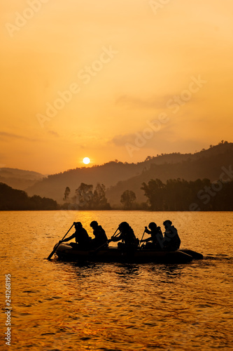 Soldeirs row boat at sunrise.