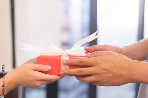 close up man hand giving red gift box to woman in house on valentine s day festival concept   