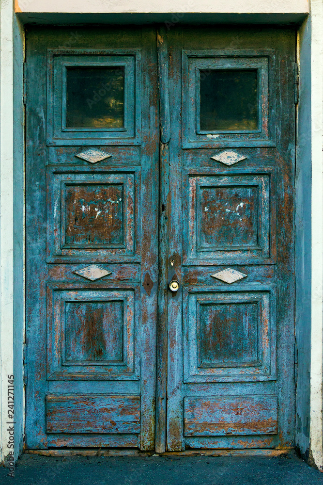 Emergency entrance door with glass inserts and old paint. Emergency entrance door with glass inserts and old paint.