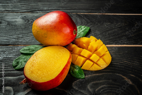 Close-up tropical fruit Mango on a dark wooden background. Flat lay. place for text. Food concept