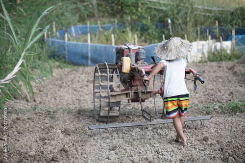 Child labor, Poor children driving a plow farming area, Children have to work because of poverty, World Day Against Child Labour concept.