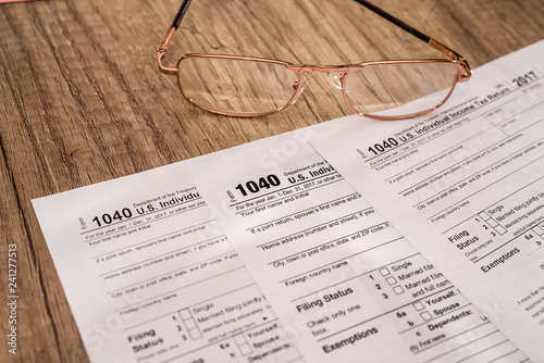Individual tax form 1040 with pen and glasses