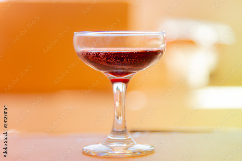 Red wine glass on background.