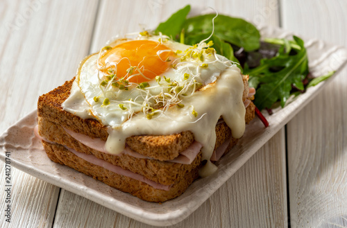 Croque madame, hot french toasts with ham , cheese and egg.  photo