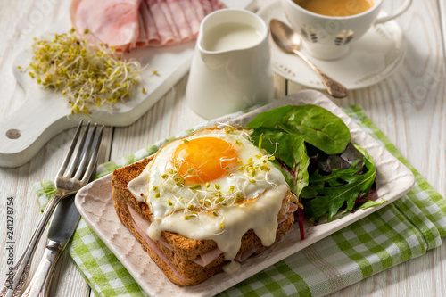 Croque madame, hot french toasts with ham , cheese and egg. 