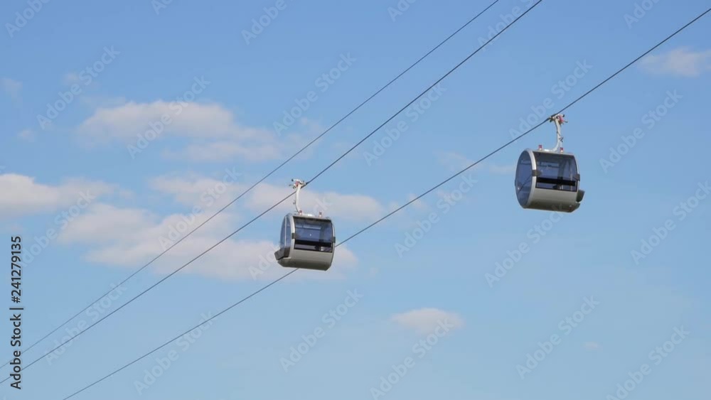 Two funicular cabins slowly moving in the air Two funicular cabins slowly moving in the air