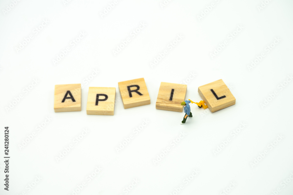 Miniature people Construction worker standing with wood word Month. using as background business concept and calendar concept with copy space for your text Miniature people Construction worker standing with wood word Month. using as background business concept and calendar concept with copy space for your text