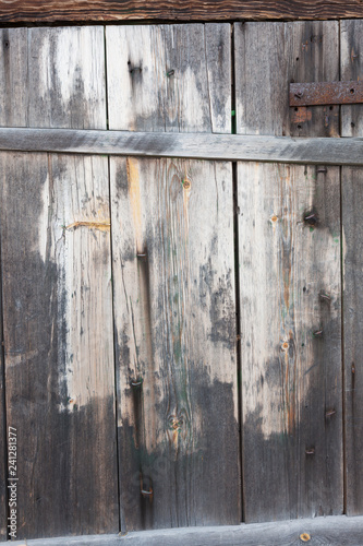 Old worn wooden barn door texture background