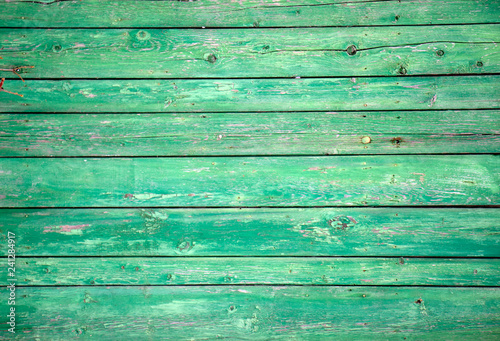 The old wooden walls painted green. Old wooden wall background or texture.