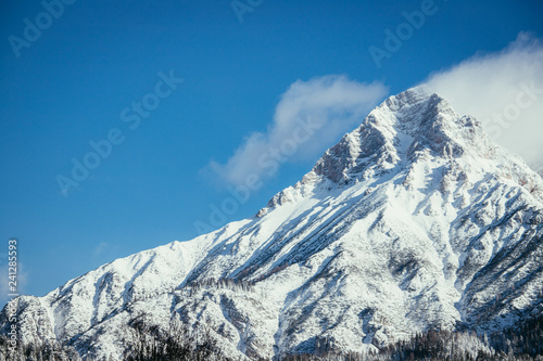 Epic snowy mountain peak with clouds in winter, landscape, alps, austria