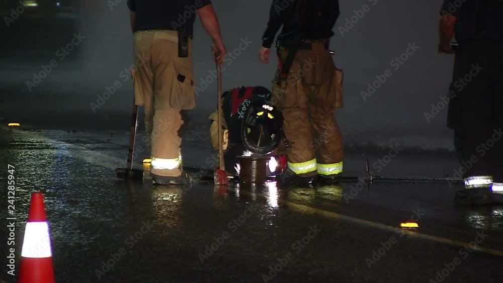 FIREFIGHTERS WORK TO SHUT OFF FIRE HYDRANT WATER MAIN Stock ビデオ Adobe