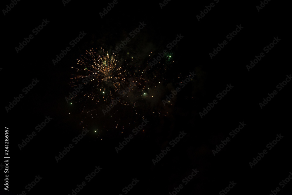 Fototapeta premium fireworks and smoke on the background of the night, misty sky