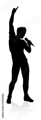 A singer pop, country music, rock star or hiphop rapper artist vocalist singing in silhouette