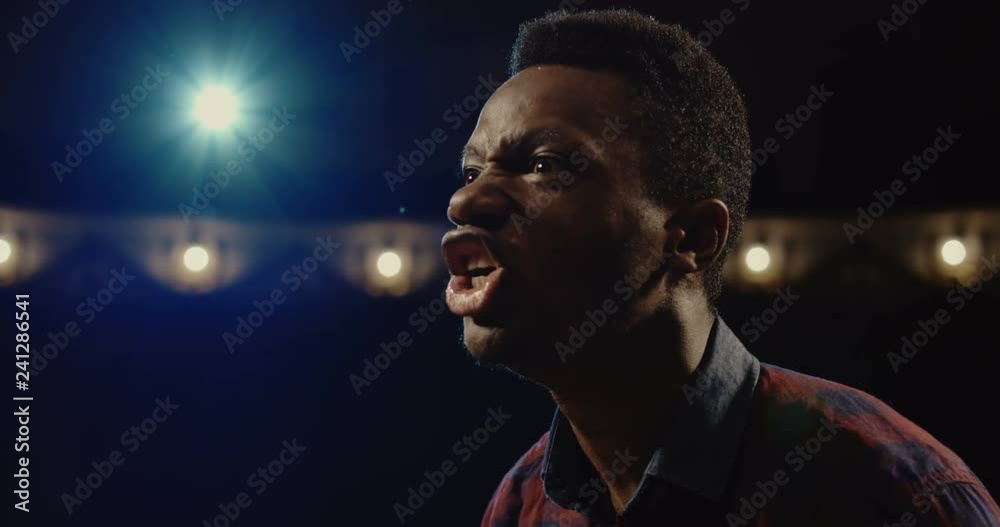 Medium close-up shot of an actor performing a monologue in a theater while holding his script Medium close-up shot of an actor performing a monologue in a theater while holding his script